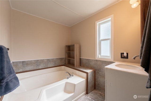 bathroom with vanity, tile walls, and a bathing tub