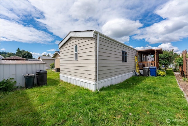 view of home's exterior with a yard and a shed