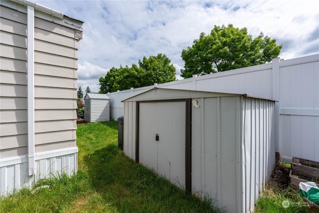 view of outbuilding featuring a lawn