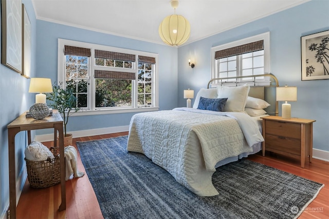 bedroom with ornamental molding and wood-type flooring