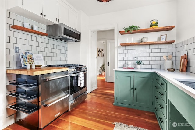 kitchen featuring white cabinetry, green cabinets, appliances with stainless steel finishes, and light hardwood / wood-style floors