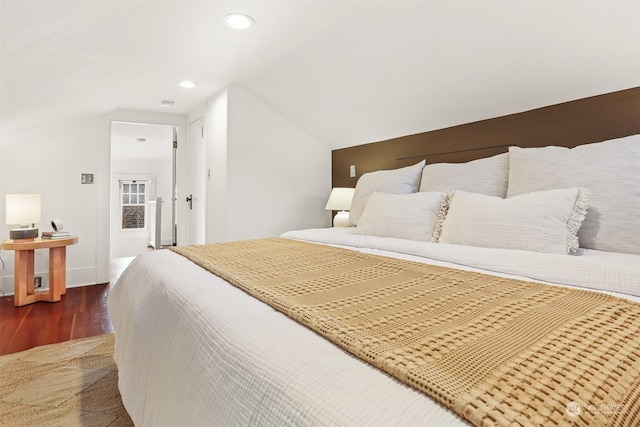 bedroom featuring dark wood-type flooring and lofted ceiling