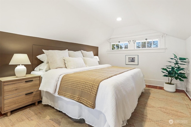 bedroom with lofted ceiling and hardwood / wood-style floors