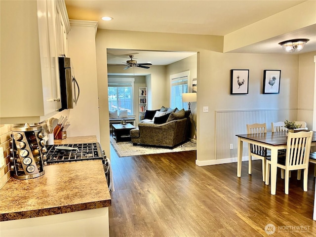 dining space with baseboards, a ceiling fan, dark wood-type flooring, and recessed lighting