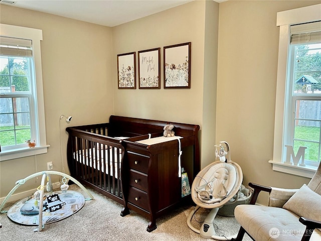 carpeted bedroom with multiple windows and visible vents