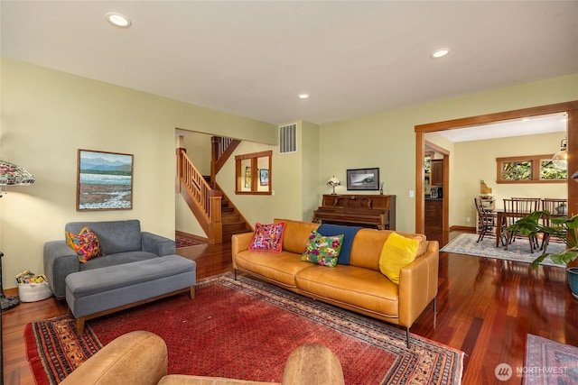 living area with visible vents, recessed lighting, stairs, and wood finished floors