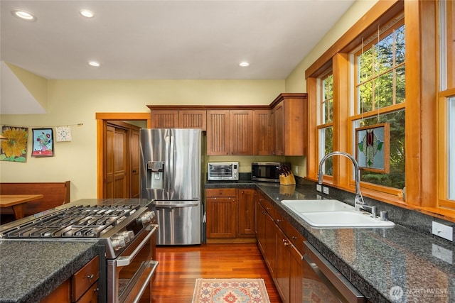 kitchen with a toaster, recessed lighting, a sink, dark wood finished floors, and stainless steel appliances