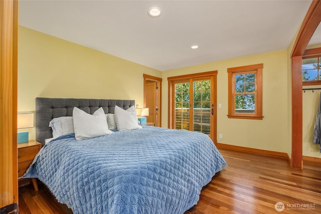 bedroom featuring access to outside, recessed lighting, baseboards, and wood finished floors
