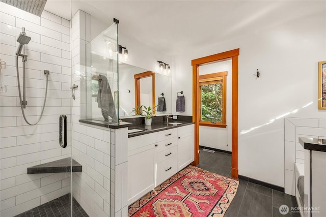 full bath with vanity, tile patterned floors, and a stall shower