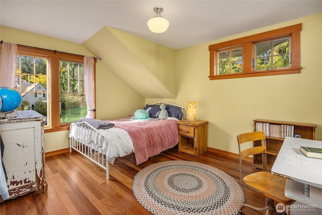 bedroom featuring baseboards and wood finished floors