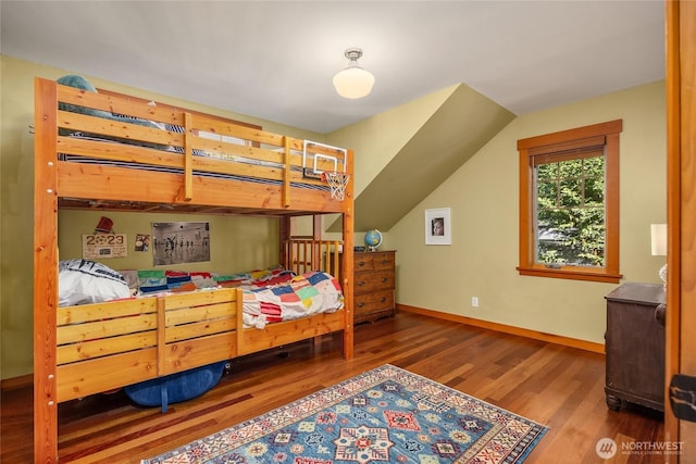 bedroom with baseboards and wood finished floors
