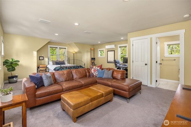 carpeted living area featuring a healthy amount of sunlight, baseboards, recessed lighting, and visible vents