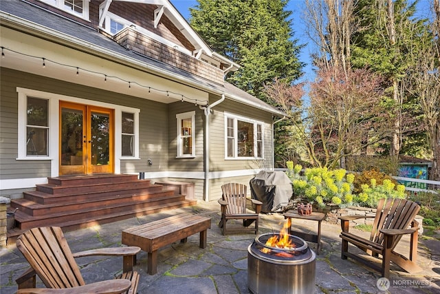 view of patio featuring an outdoor fire pit, french doors, area for grilling, and entry steps
