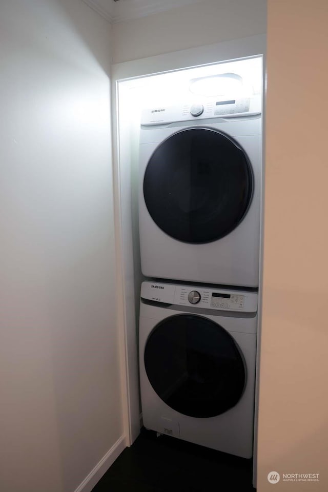 washroom with stacked washer / drying machine