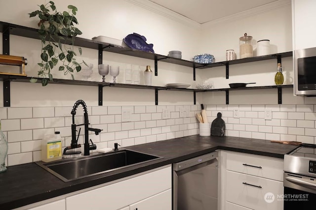 kitchen featuring appliances with stainless steel finishes, white cabinetry, sink, backsplash, and crown molding