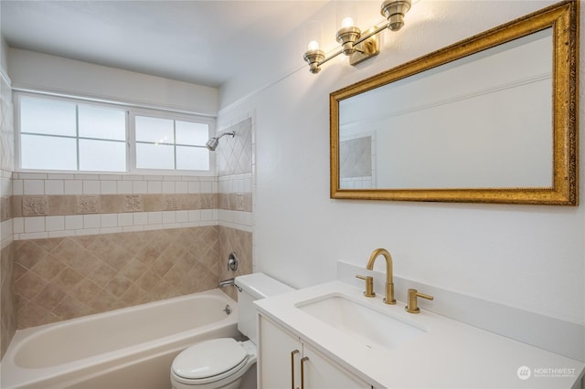 full bathroom with vanity, tiled shower / bath, and toilet