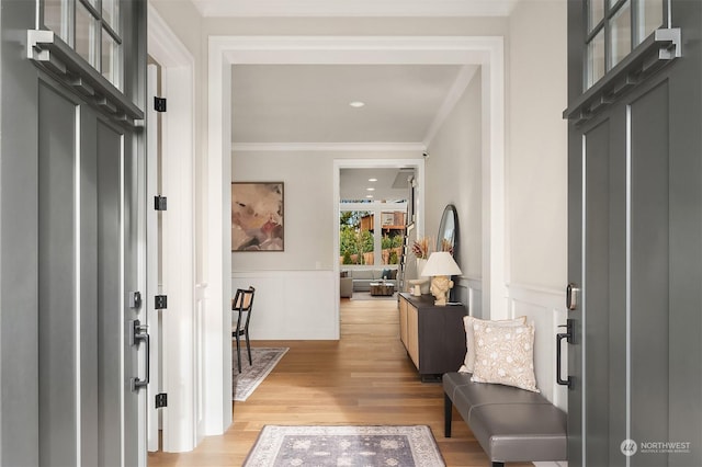 mudroom featuring light hardwood / wood-style flooring and ornamental molding