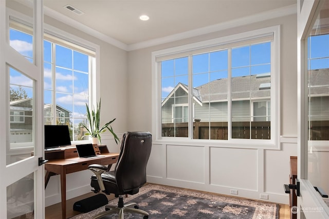 office space with a wealth of natural light and ornamental molding