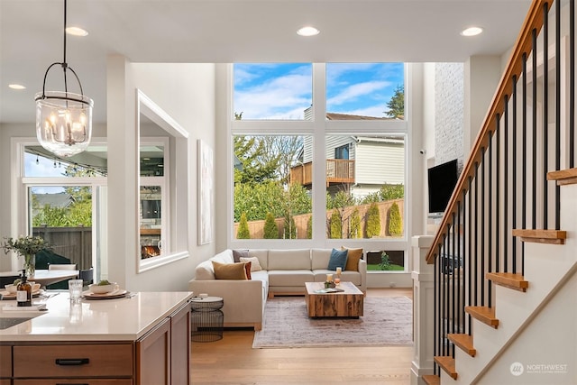 sunroom with a healthy amount of sunlight and a notable chandelier