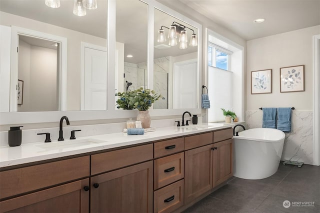 bathroom featuring tile patterned floors, vanity, plus walk in shower, and tile walls