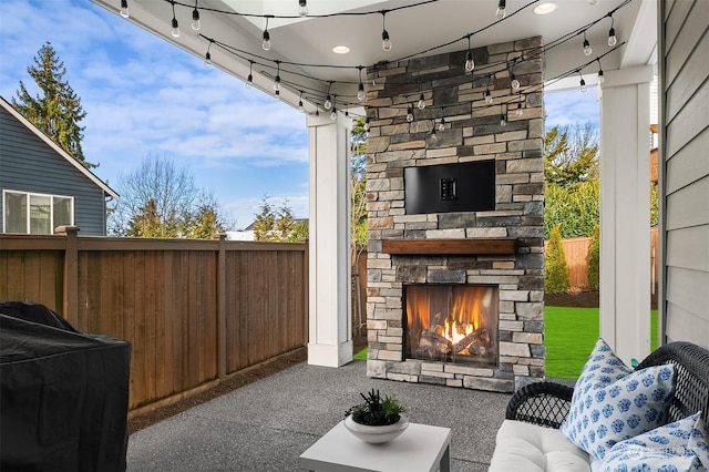 view of patio featuring an outdoor stone fireplace