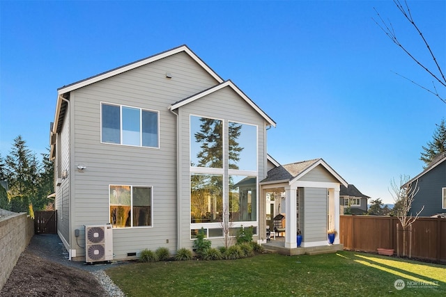 rear view of property with a lawn and ac unit