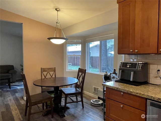 dining space with dark hardwood / wood-style flooring