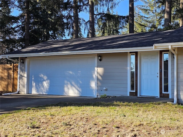 exterior space featuring a garage and a lawn