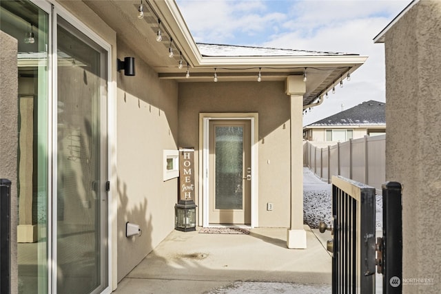 view of exterior entry with a patio area