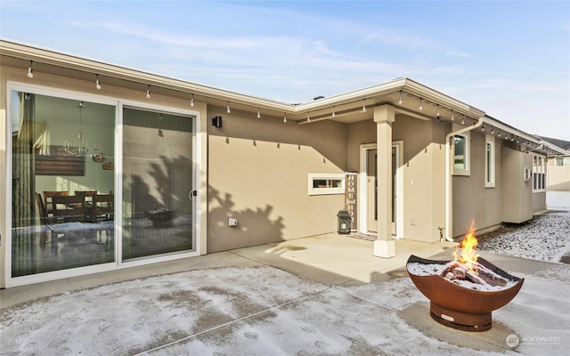 back of house with a patio and an outdoor fire pit