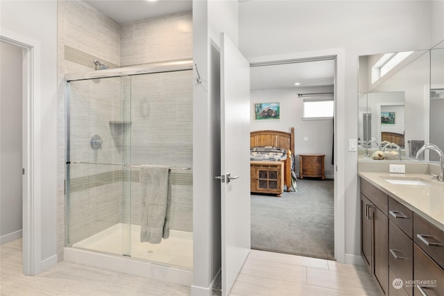 bathroom with vanity and a shower with door