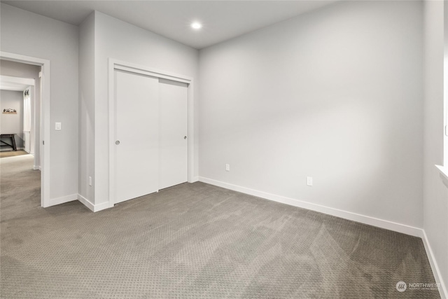 unfurnished bedroom with a closet and carpet