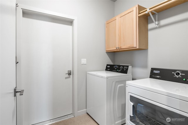 laundry area featuring cabinets and washing machine and clothes dryer