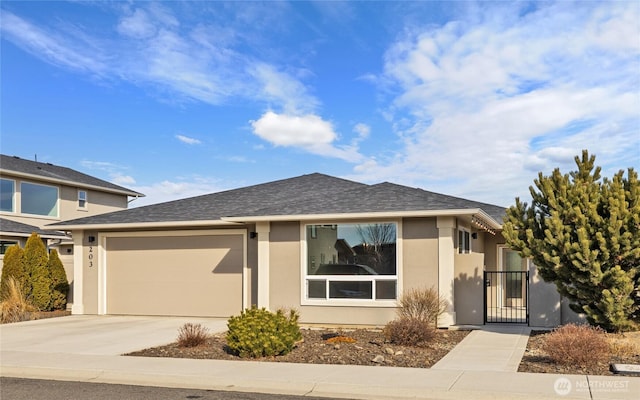 203 E Chason Ave, Ellensburg, WA 98926 - single story home featuring stucco siding, driveway, a garage, a gate, and a shingled roof