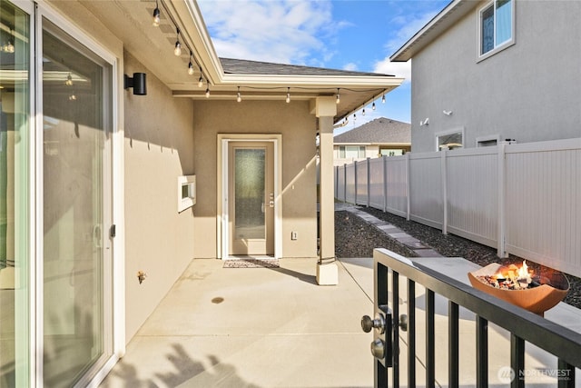 view of patio / terrace with fence and a fire pit