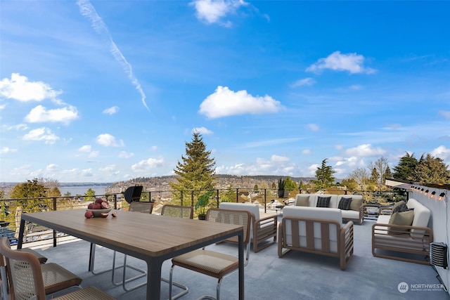 view of patio with a water view and an outdoor living space