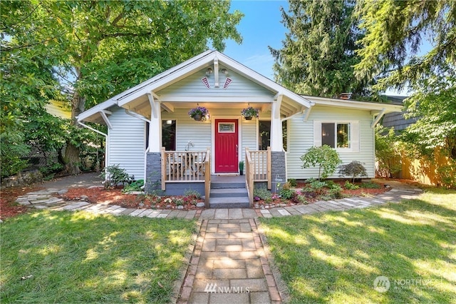 view of front of property with a porch and a front lawn