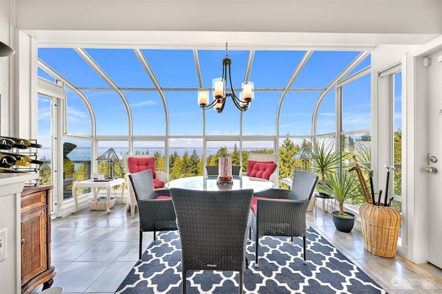 sunroom / solarium with a healthy amount of sunlight and a chandelier