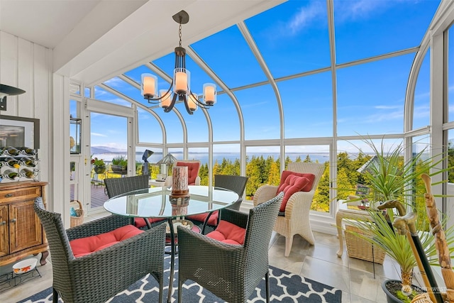 sunroom / solarium featuring an inviting chandelier