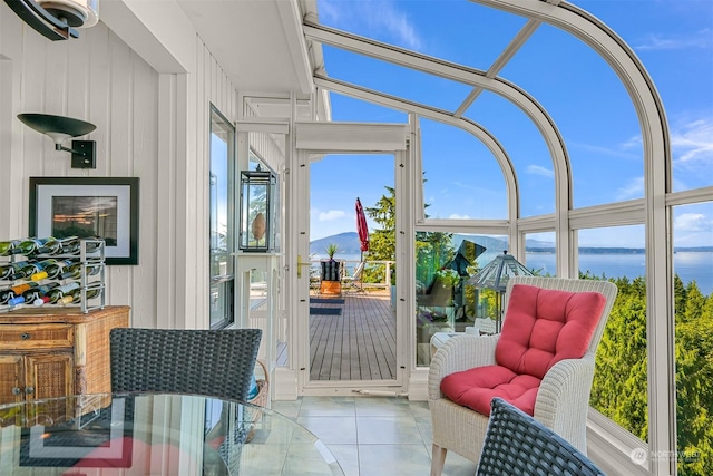 sunroom / solarium featuring a water view