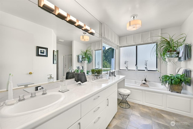 bathroom with vanity, a bathtub, and tile patterned floors