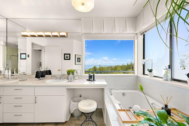 bathroom with vanity and a relaxing tiled tub