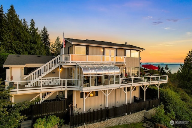 view of back house at dusk