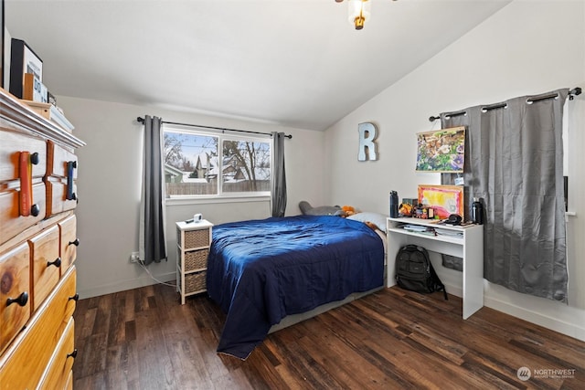 bedroom with vaulted ceiling and dark hardwood / wood-style flooring