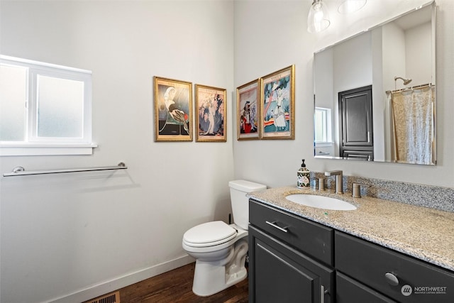 bathroom featuring a shower with curtain, vanity, hardwood / wood-style floors, and toilet