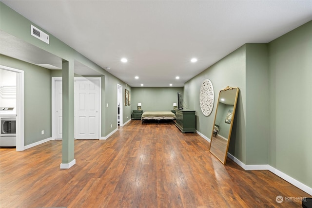 interior space with dark hardwood / wood-style flooring and washer / dryer