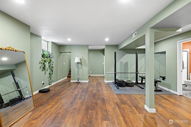 workout room with dark wood-type flooring