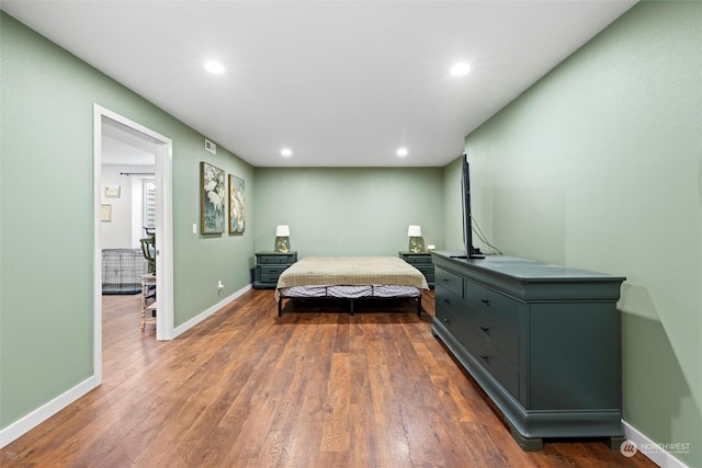 bedroom with dark hardwood / wood-style flooring