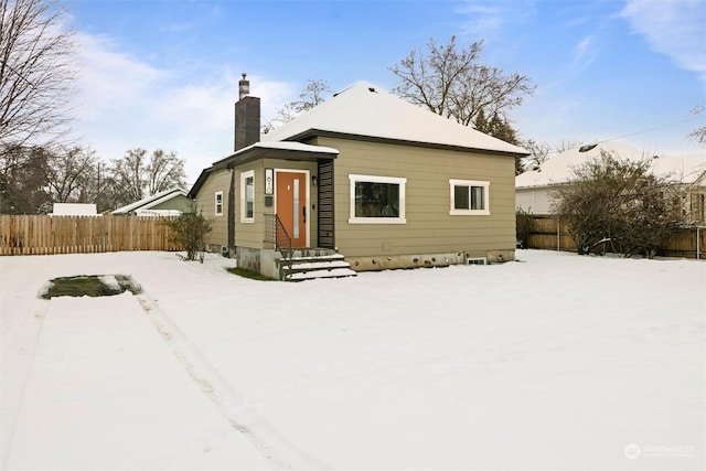 view of snow covered rear of property