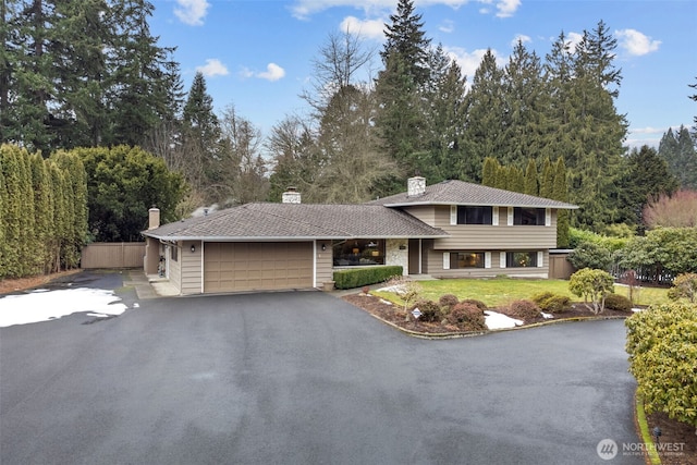 split level home with a front yard and a garage